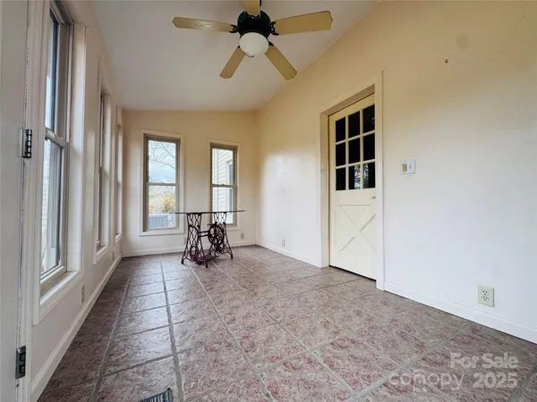 a view of a livingroom with a ceiling fan and window