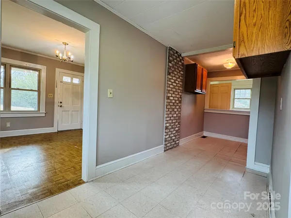 an empty room with a fireplace and windows