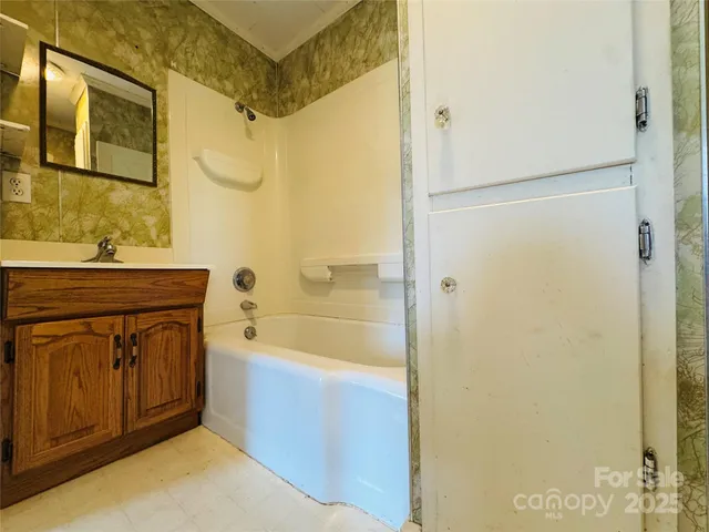 a bathroom with a sink mirror toilet and bathtub