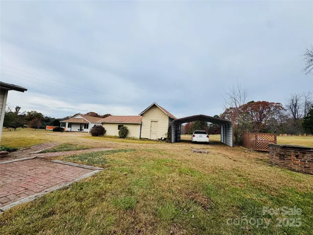 a large house with a big yard and large trees