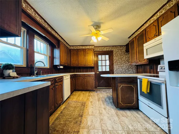 a kitchen with a sink cabinets and window