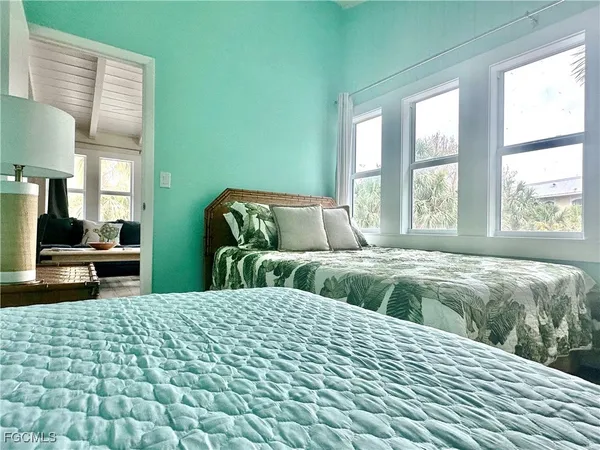 a bedroom with two beds and a couch