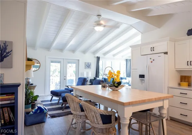 a view of a dining room with furniture and a chandelier
