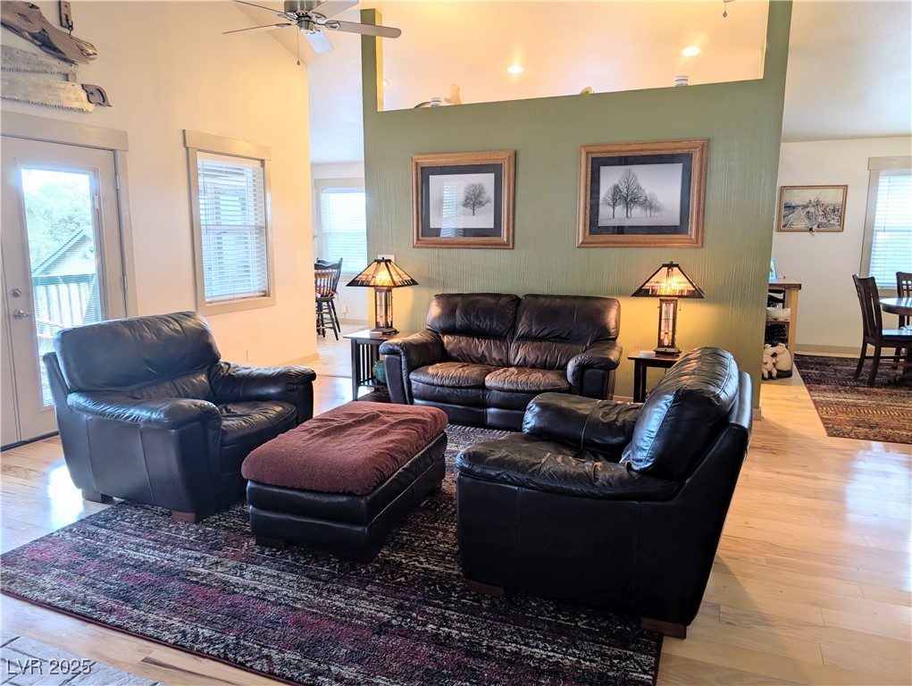 8320 Mother Lode Road Pioche, NV 89043 - Photo 23 of 46 Living room featuring light wood-style flooring, a towering ceiling, and two ceiling fans