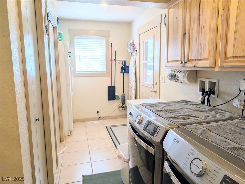 8320 Mother Lode Road Pioche, NV 89043 - Photo 39 of 46 Washroom featuring ceramic tile floors, washer and dryer, and cabinet space