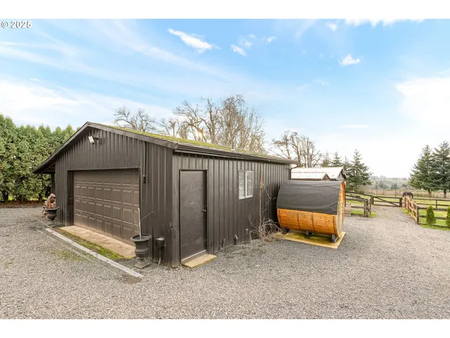 a backyard of a house with barbeque oven and outdoor seating