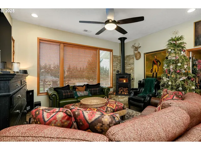 a living room with furniture ceiling fan and a flat screen tv