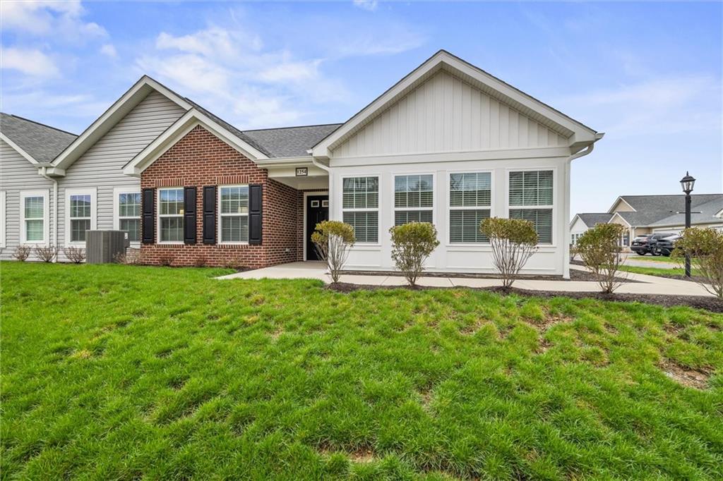 a front view of house with yard and green space