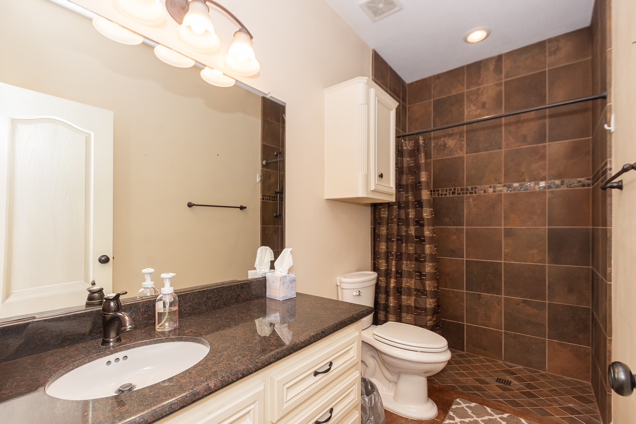 5 Shore Acres Circle Shoreacres, TX 77571 - Photo 18 of 38 a bathroom with a granite countertop sink a toilet and a mirror