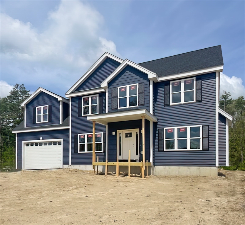 Lot 1 Valley Road Lunenburg, MA 01462 - Photo 3 of 12 a front view of a house with yard and parking