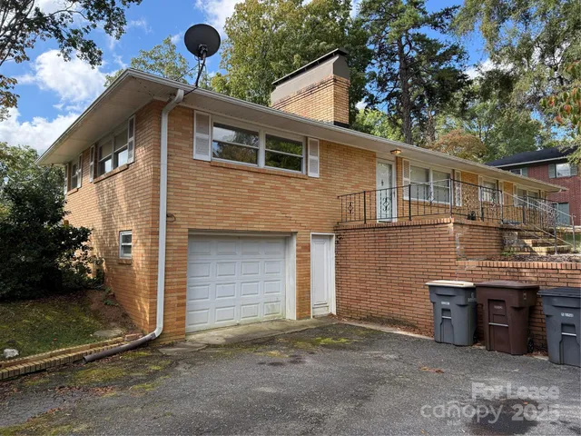 a view of house with swimming pool and sitting space