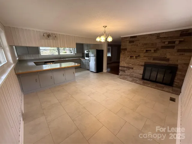 a kitchen with stainless steel appliances kitchen island granite countertop a sink and cabinets