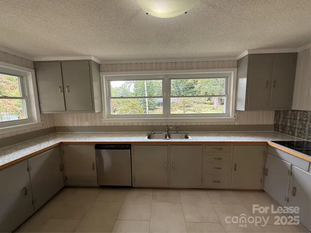a kitchen with a refrigerator sink and cabinets
