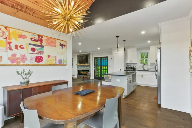a dining room with furniture and wooden floor