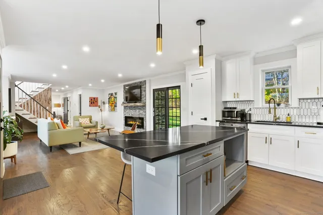 a kitchen with stainless steel appliances granite countertop a sink and stove