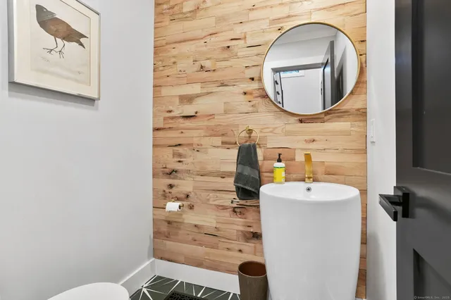 a bathroom with a sink mirror and toilet