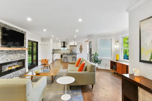 a living room with fireplace furniture and a flat screen tv