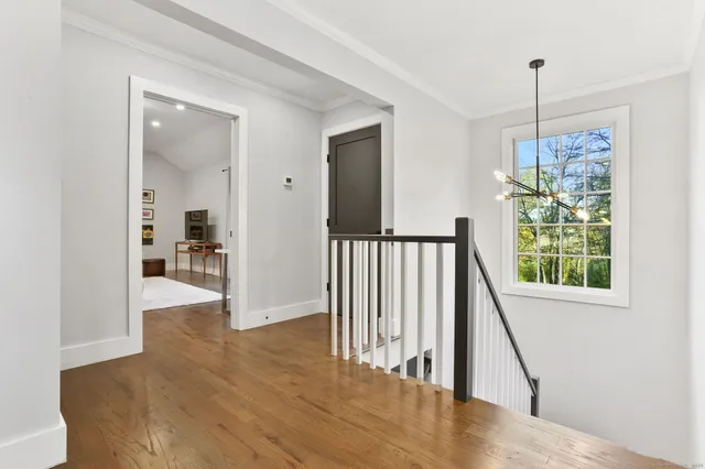 a view of an entryway with wooden floor and a dining room