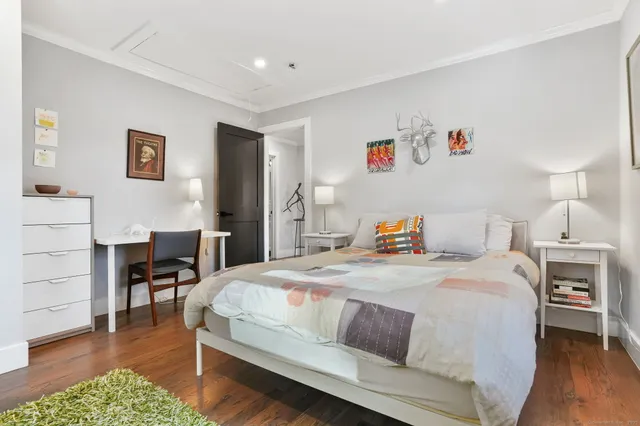 a bedroom with a bed and a table in it