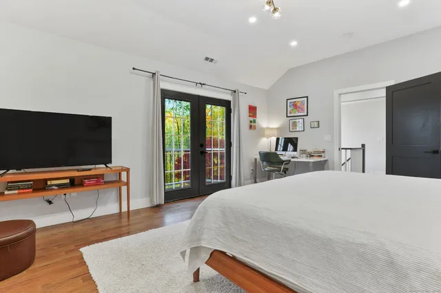 a bedroom with furniture and a flat screen tv