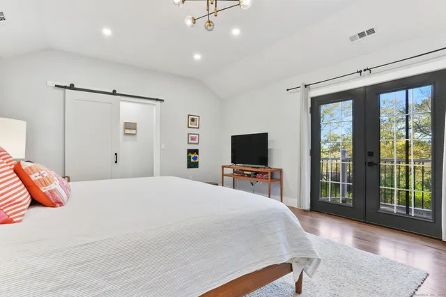 a bedroom with a bed and a flat screen tv