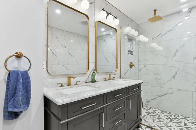 a bathroom with a granite countertop sink and a mirror