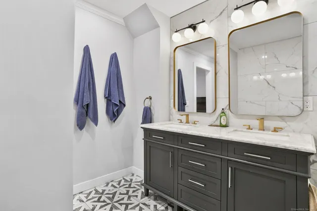 a bathroom with a double vanity sink and a mirror