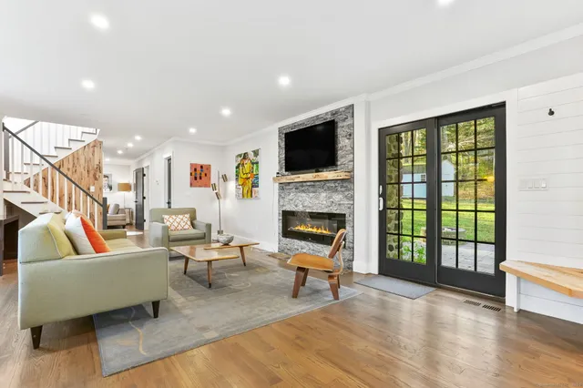 a living room with furniture fireplace and a flat screen tv