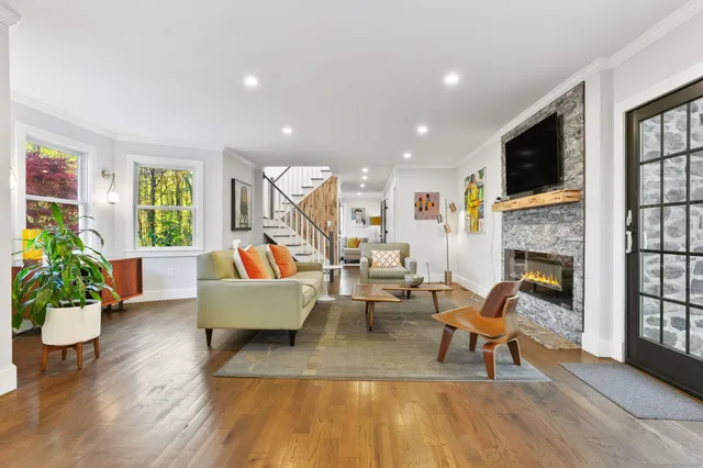 a living room with furniture fireplace and flat screen tv