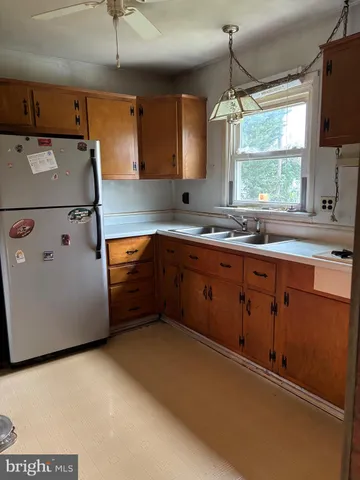 a kitchen with sink a window and appliances