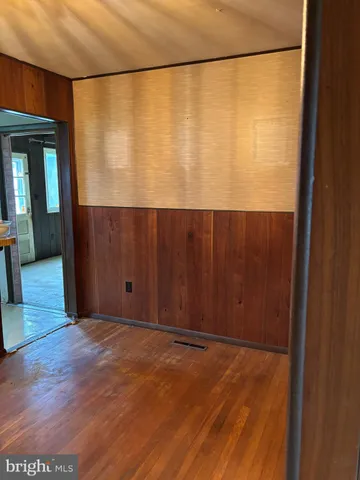 a view of a room with wooden floor and a window