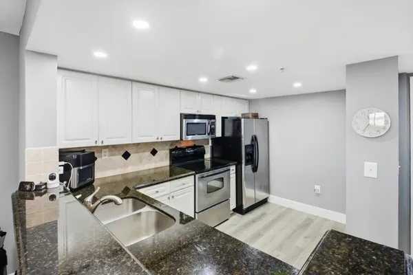 a kitchen with a sink stove and cabinets