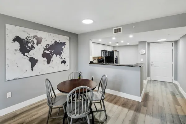 a kitchen with stainless steel appliances white cabinets and a refrigerator