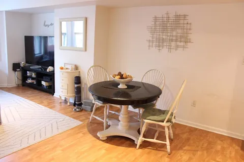 a dining room with furniture and wooden floor