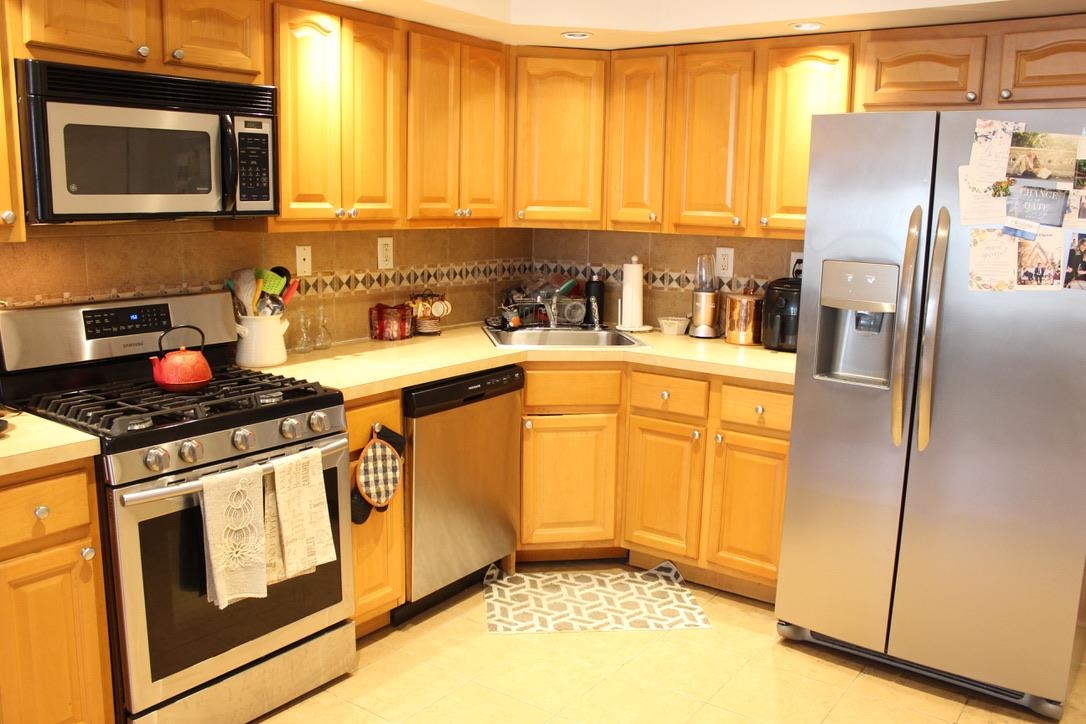 210 Adams Street, Unit 2 Hoboken, NJ 07030 - Photo 3 of 11 a kitchen with stainless steel appliances granite countertop a stove a sink and a microwave