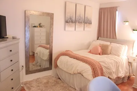 a bedroom with a bed and a mirror