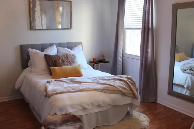 a bed sitting in a bedroom next to a window