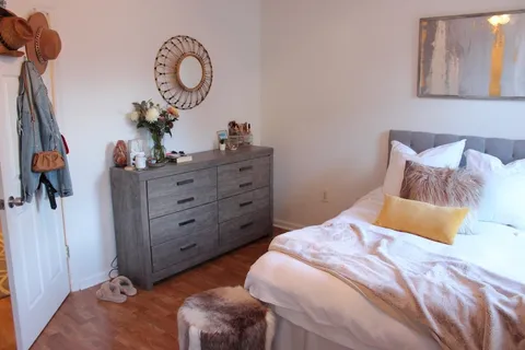a bedroom with a bed and a dresser in it