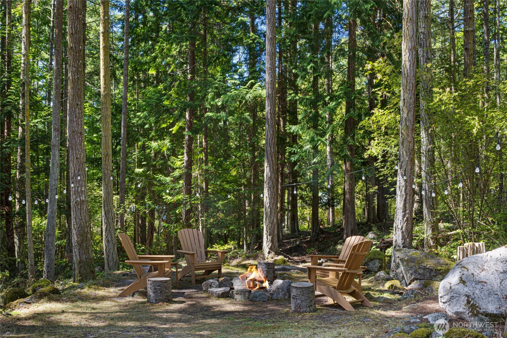 65 Sutherland Road Friday Harbor, WA 98250 - Photo 31 of 39 a view of backyard with table and chairs and wooden fence