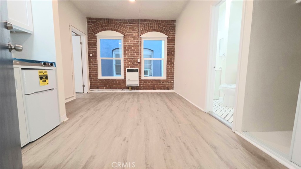 3408 Sunset Boulevard, Unit 107 Silver Lake, CA 90026 - Photo 1 of 12 a view of a room with wooden floor and entryway