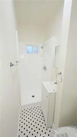 a bathroom with a sink a toilet and a shower