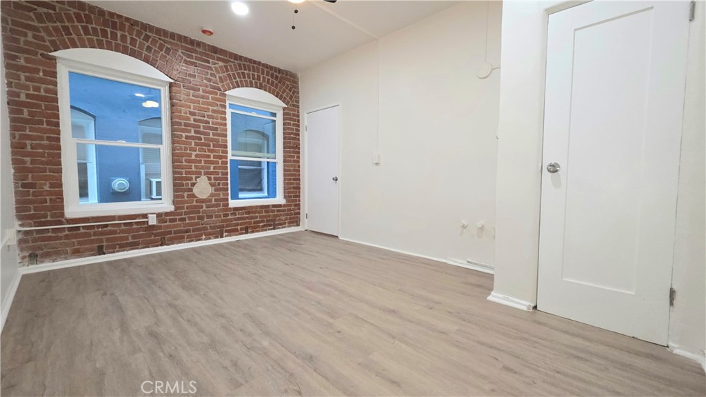3408 Sunset Boulevard, Unit 107 Silver Lake, CA 90026 - Photo 9 of 12 an empty room with wooden floor and windows