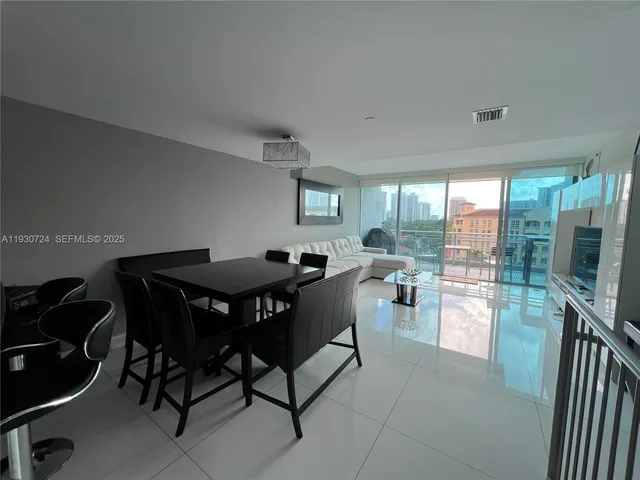 a view of a dining room with furniture and a potted plant