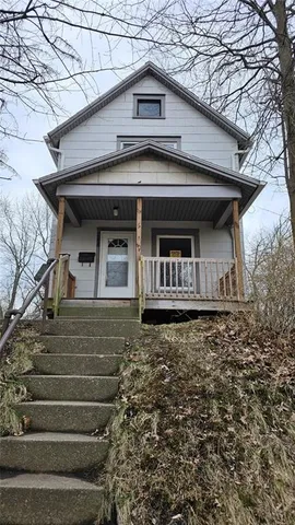 a front view of a house with stairs
