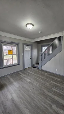 a view of an empty room and wooden floor