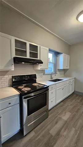 a kitchen with stainless steel appliances granite countertop a stove and a sink