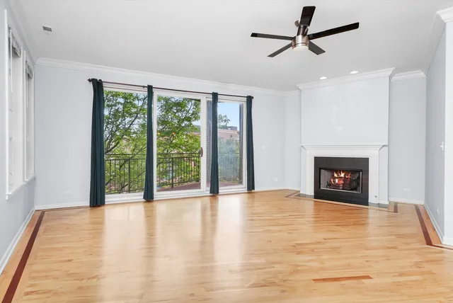a view of an empty room with a fireplace and a window