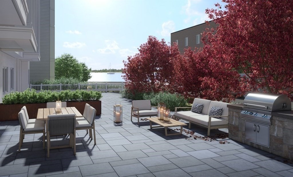 142 P Street, Unit 1 Boston, MA 02127 - Photo 3 of 6 a backyard of a house with outdoor seating