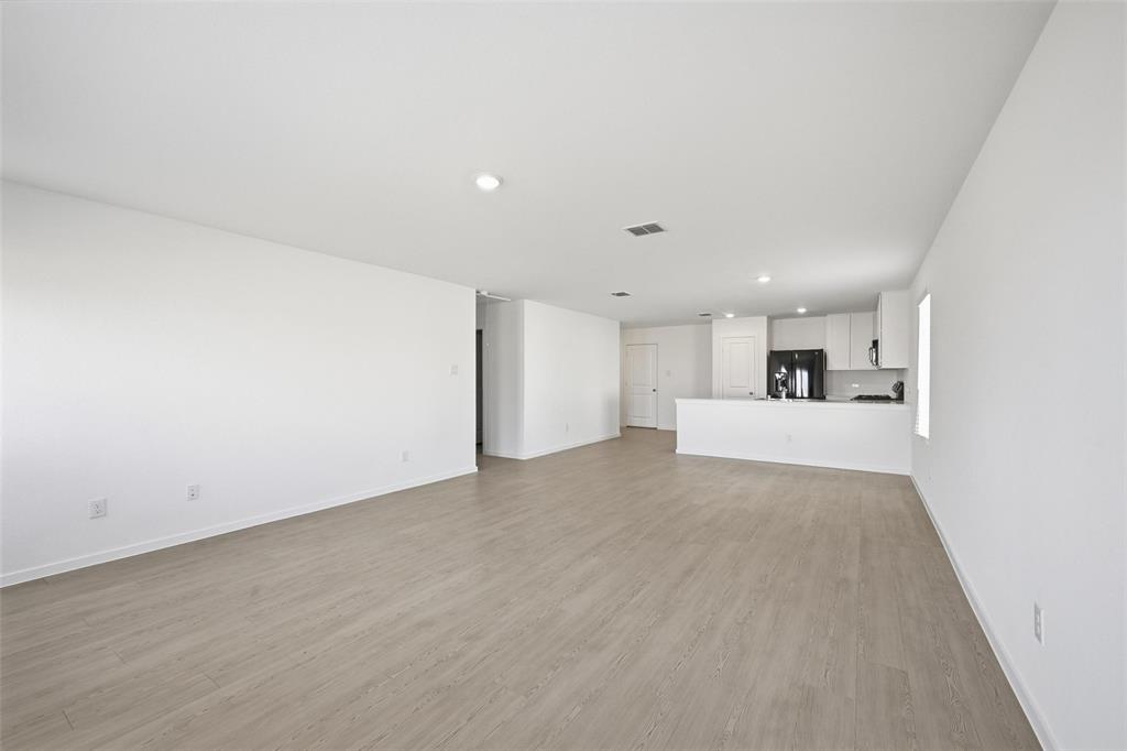 3707 Spring Run Drive Sherman, TX 75092 - Photo 4 of 18 a view of a kitchen with a sink and a refrigerator