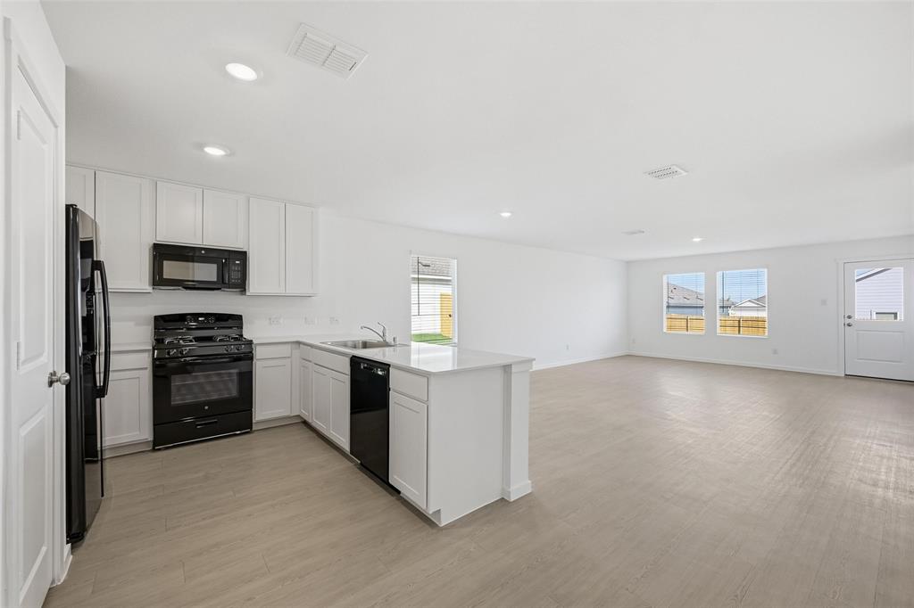 3707 Spring Run Drive Sherman, TX 75092 - Photo 18 of 18 a kitchen with a refrigerator and a stove top oven